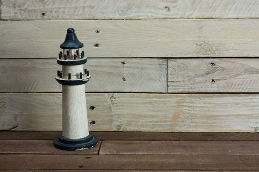 Lighthouse set against a worn wooden background