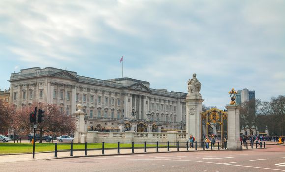 LONDON - APRIL 5: Buckingham palace with crowd of tourists on April 5, 2015 in London, UK. It's the London residence and principal workplace of the monarchy of the United Kingdom.