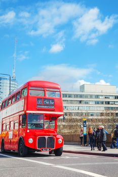 LONDON - APRIL 5: Iconic red double decker bus on April 5, 2015 in London, UK. The London Bus is one of London's principal icons, the archetypal red rear-entrance Routemaster recognised worldwide.