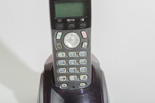 Black cordless phone on a white background
