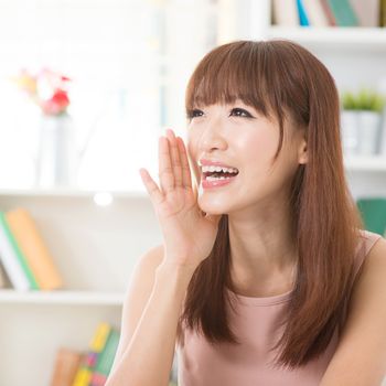 Portrait of happy Asian girl shouting and smiling at home. Woman living lifestyle, indoors.