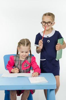 Two girls play school teacher and student