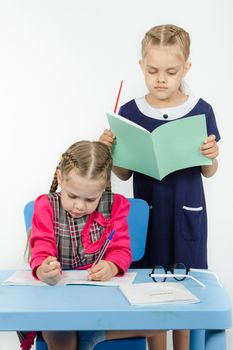 Two girls play school teacher and student