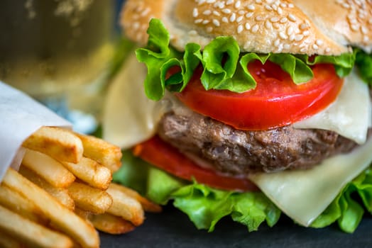 Closeup of Homemade Hamburger with Fresh Vegetables and French Fries