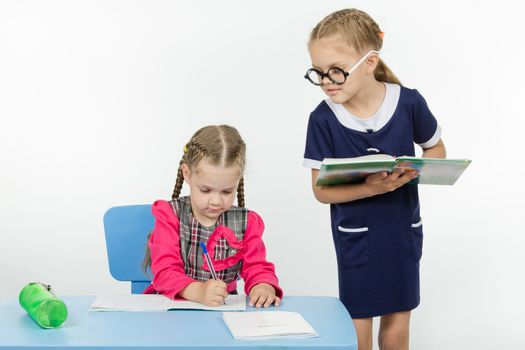 Two girls play school teacher and student