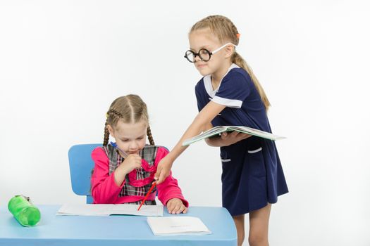 Two girls play school teacher and student
