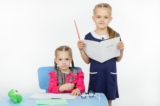 Two girls play school teacher and student