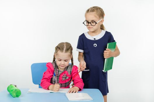 Two girls play school teacher and student