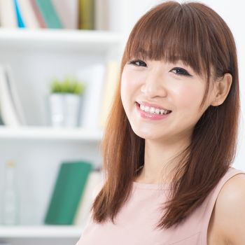 Portrait of attractive Asian girl smiling. Young woman indoors living lifestyle at home.