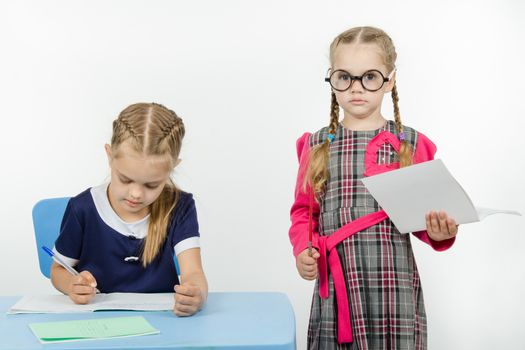 Two girls play school teacher and student