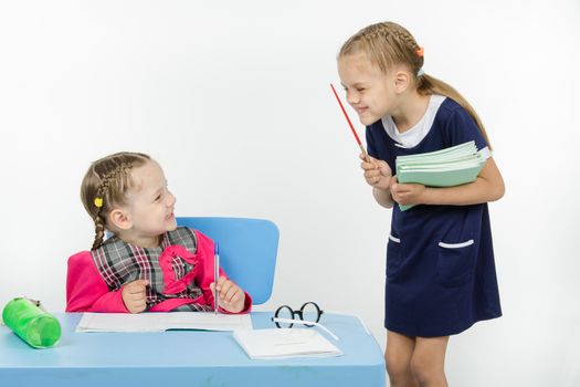 Two girls play school teacher and student