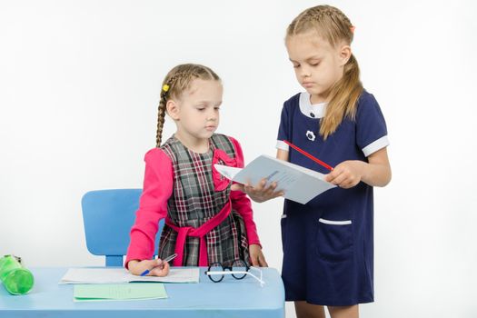 Two girls play school teacher and student