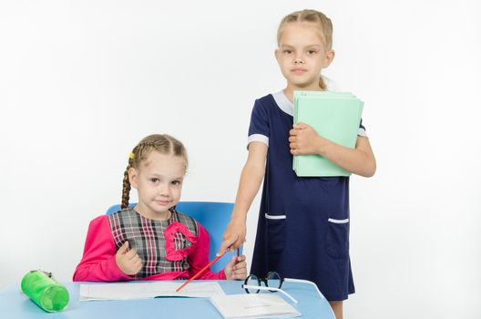 Two girls play school teacher and student