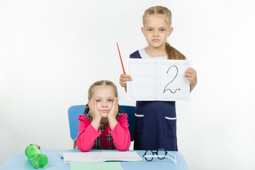 Two girls play school teacher and student