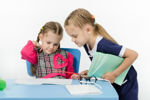 Two girls play school teacher and student
