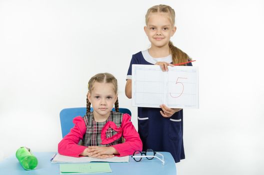 Two girls play school teacher and student