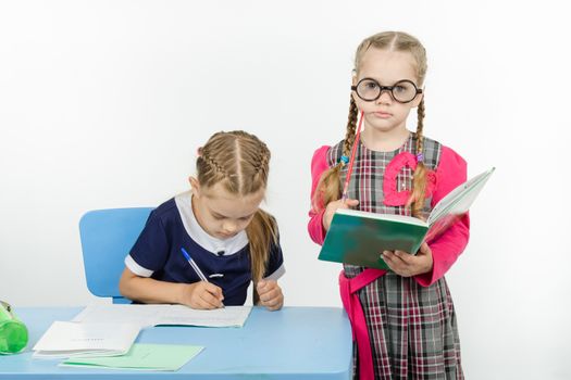 Two girls play school teacher and student