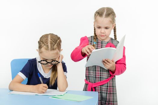 Two girls play school teacher and student