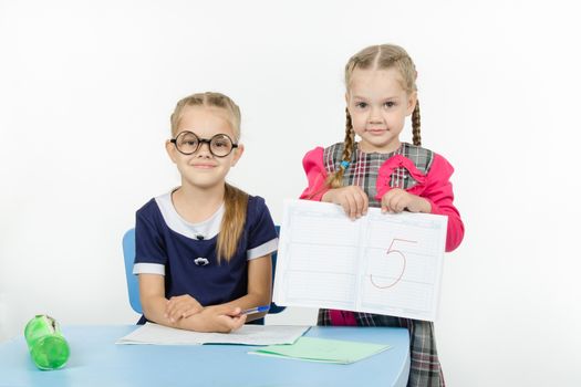 Two girls play school teacher and student