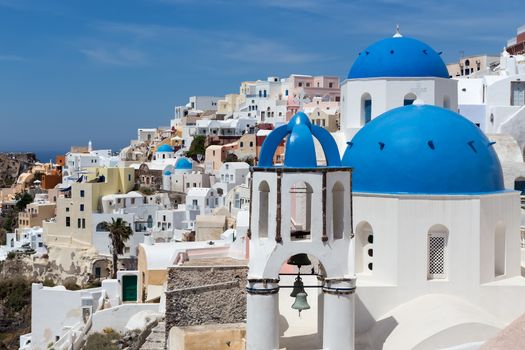 Blue and white church of Oia village on Santorini island. Greece