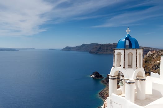 Blue and white church of Oia village on Santorini island. Greece