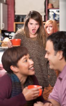 Shocked woman with coffee finding boyfriend in cafe