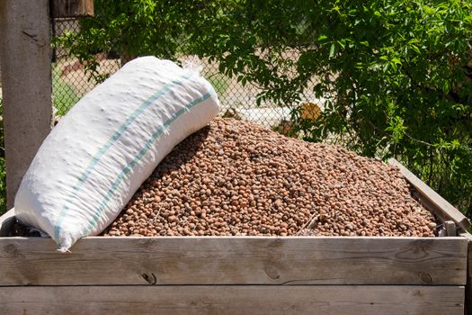 Homemade wooden box with a slide filled expanded clay, expanded clay on top of a sack