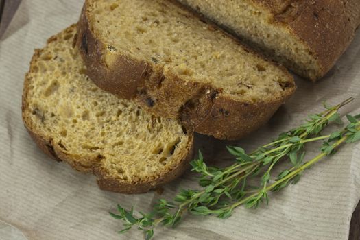 Cut fresh wholemeal bread on a sheet of brown paper