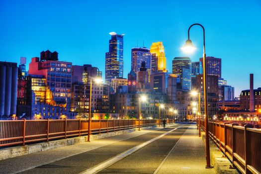 Downtown Minneapolis, Minnesota at night time as seen from the famous stone arch bridge