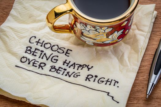 Choose being happy over being right - inspirational advice - handwriting on a napkin with cup of coffee