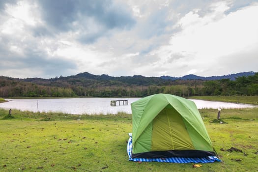 Camping in forest with lake and sky