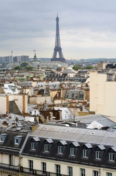 Eiffel Tower with roofs of Paris, France