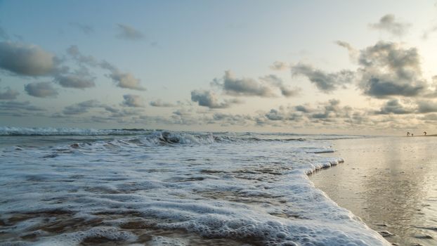 Waves of the Atlantic Ocean landing on the shores of Obama Beach in Cotonou, Benin