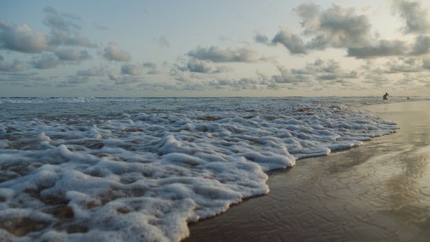 Waves of the Atlantic Ocean landing on the shores of Obama Beach in Cotonou, Benin