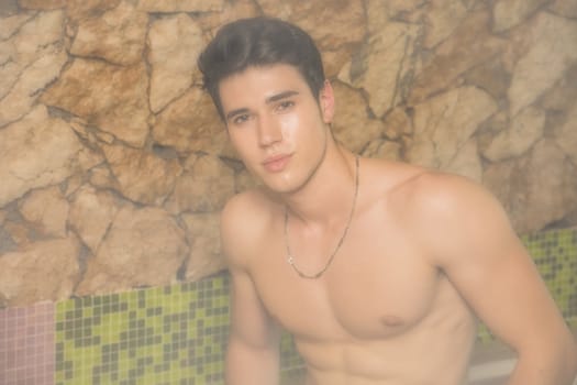 Young Shirtless Man Gazing Seductively at Camera and Relaxing in Steam Sauna - Turkish Bath - Sweating