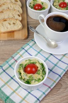 Omelet  spinach and cheese in the form of a batch with a cup of coffee