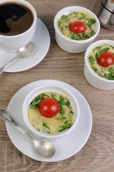 Omelet  spinach and cheese in the form of a batch with a cup of coffee