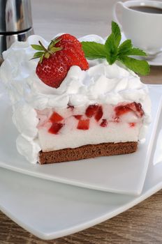 Strawberry soufflé on a chocolate sponge cake with whipped cream