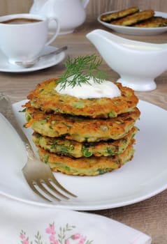 Vegetable fritters of zucchini with peas and herbs