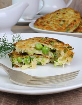 Vegetable fritters of zucchini with peas and herbs