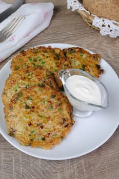 Vegetable fritters of zucchini with peas and herbs