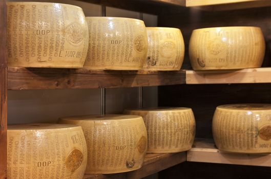 typical italian seasoned cheese called parmigiano,