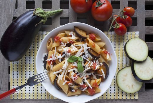 typical italian food: sicilian pasta, called "Norma", with tomato, aubergines and ricotta cheese