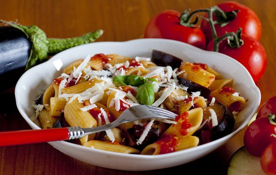 typical italian food: sicilian pasta, called "Norma", with tomato, aubergines and ricotta cheese
