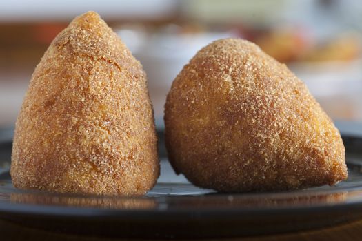 typical italian food: sicilian food called "arancini", made with rice and ragout inside