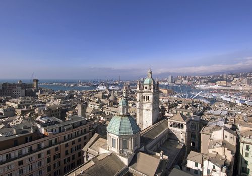 view of genoa, italy, with tower of cathedral and the harbor