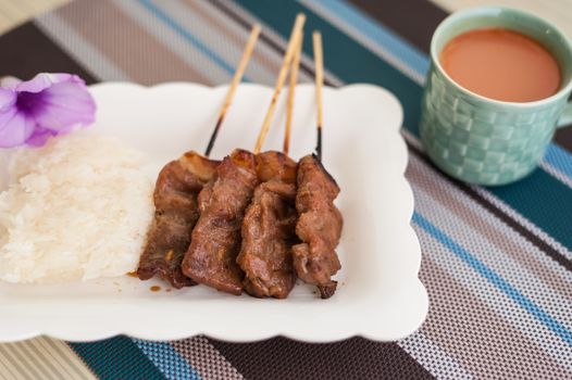 Thai-style roasted pork, grilled pork, pork steak, barbecue pork on skewers (Moo Yang, Mu Ping) shoot soft focus