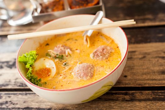 Thai food, Pork noodle tom yum, Water egg on wood table