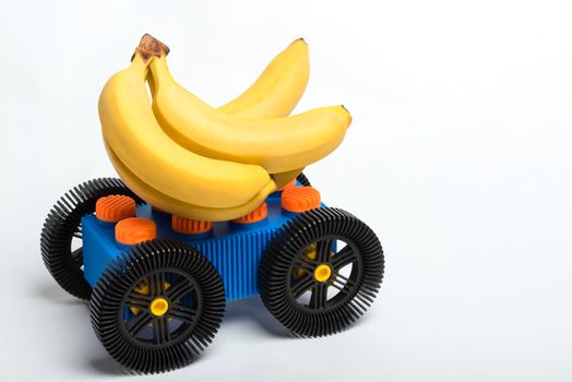 Bananas on top of a car made from children's blocks representing the idiomatic phrase "gone bananas."