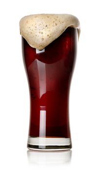 Froth on black beer in glass isolated on white